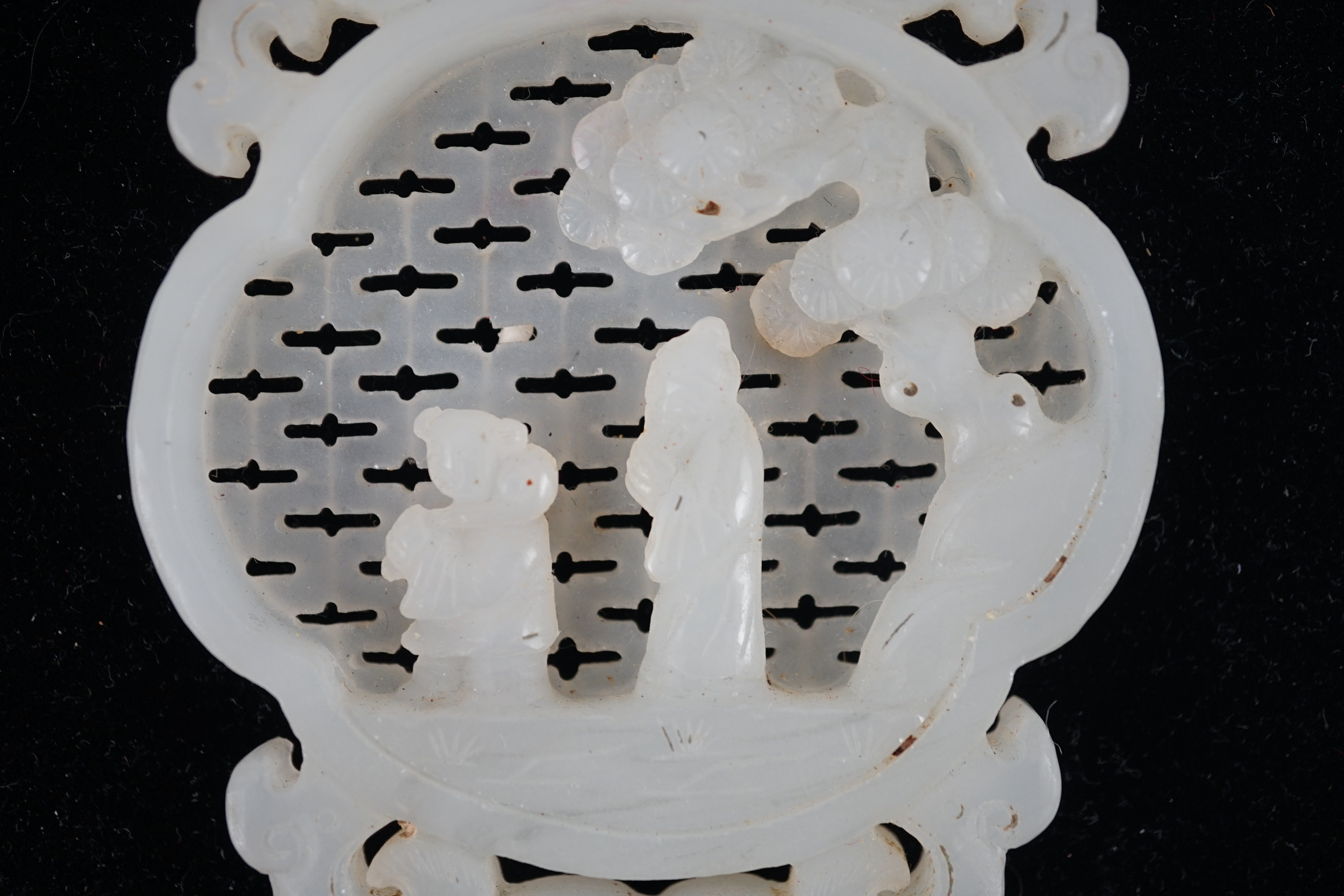 A Chinese white jade reticulated plaque, 19th century, 10.2cm high